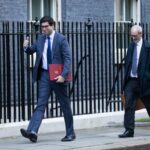 Ranil Jayawardena (left), the environment secretary, giving a thumbs up to reporters as he arrived for cabinet this morning.