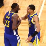 FILE-Jordan Poole #3 and Draymond Green #23 of the Golden State Warriors celebrate against the Boston Celtics during the fourth quarter in Game Six of the 2022 NBA Finals at TD Garden on June 16, 2022 in Boston, Massachusetts.