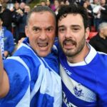 Greece player Adam Vrahnos with a supporter after the defeat to England