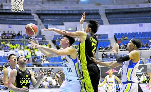 Poy Erram (middle) and TNT kick off their Commissioner’s Cup campaign against Ian Sangalang (left), Rafi Reavis and Magnolia. —PBA IMAGES