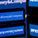 This photograph taken in Toulouse, southern France on April 12, 2022, shows screens displaying the logo of US-based McKinsey & Company management consulting firm. (Photo by Lionel BONAVENTURE / AFP)