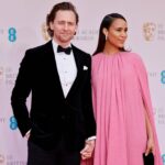 British actor Tom Hiddleston (L) and British actress Zawe Ashton pose on the red carpet upon arrival at the BAFTA British Academy Film Awards at the Royal Albert Hall, in London, on March 13, 2022. (Photo by Tolga Akmen / AFP) (Photo by TOLGA AKMEN/AFP via Getty Images)