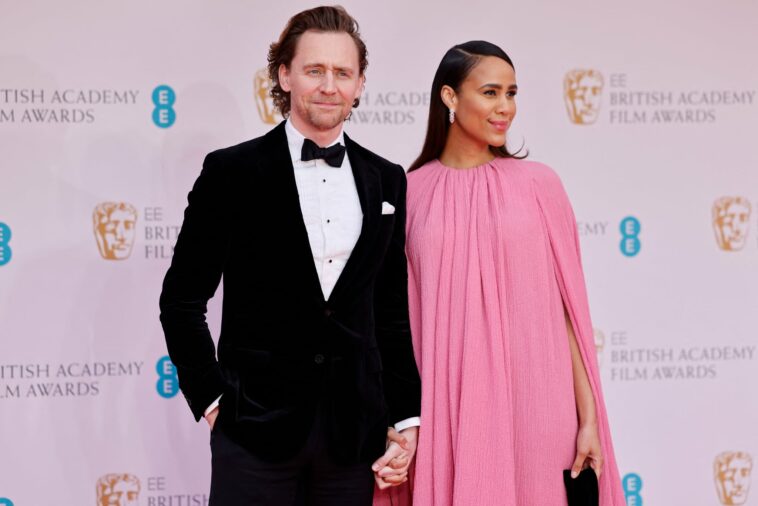 British actor Tom Hiddleston (L) and British actress Zawe Ashton pose on the red carpet upon arrival at the BAFTA British Academy Film Awards at the Royal Albert Hall, in London, on March 13, 2022. (Photo by Tolga Akmen / AFP) (Photo by TOLGA AKMEN/AFP via Getty Images)