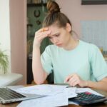 Stressed woman looks at her finances