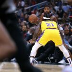 Paul George #13 of the LA Clippers looks to pass as he is guarded by Patrick Beverley #21 of the Los Angeles Lakers during a 114-101 Clippers win at Crypto.com Arena on November 09, 2022 in Los Angeles, California.