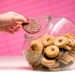 Woman stealing biscuit, caught in the act.