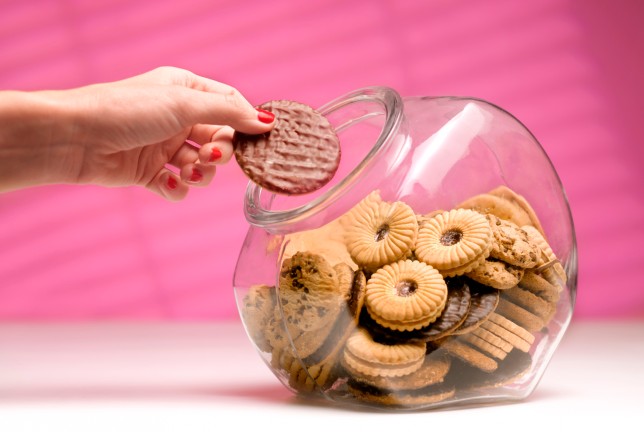 Woman stealing biscuit, caught in the act.