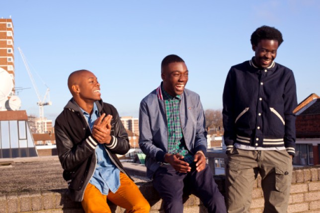 Three men laughing together