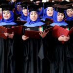 Afghan students stand to perform graduation pledges during their degree-award ceremony at a university in Herat, Afghanistan.