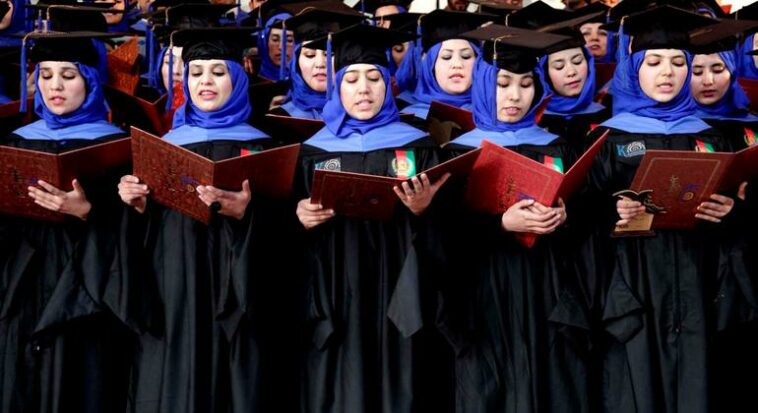 Afghan students stand to perform graduation pledges during their degree-award ceremony at a university in Herat, Afghanistan.