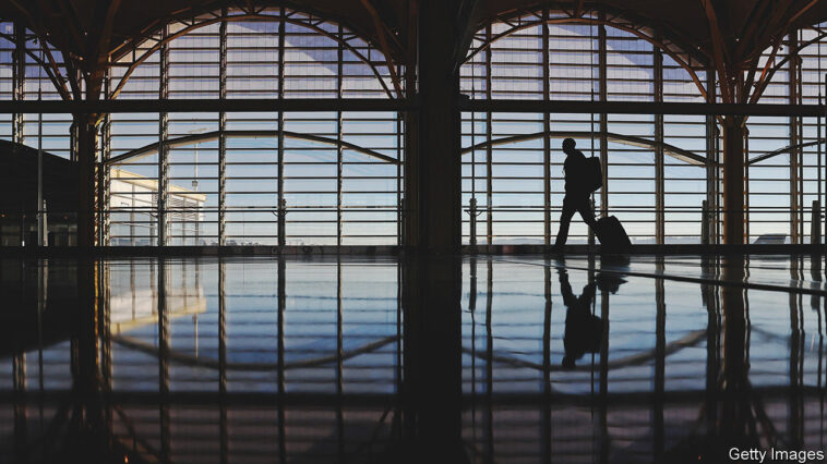 *** BESTPIX *** ARLINGTON, VIRGINIA - NOVEMBER 22: A passenger walks through Ronald Reagan Washington National Airport on November 22, 2022 in Arlington, Virginia. Airlines are preparing for an increase in passengers over the Thanksgiving holiday weekend with demand expected to reach near pre-pandemic levels. (Photo by Kevin Dietsch/Getty Images)