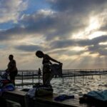 People take an early morning swim at Merewether baths on Christmas Day in Newcastle, NSW.