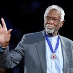 Boston Celtics' legend Bill Russell stands with his Presidential Medal of Freedom during the NBA All-Star basketball game in Los Angeles, February 20, 2011. REUTERS/Danny Moloshok/File Photo