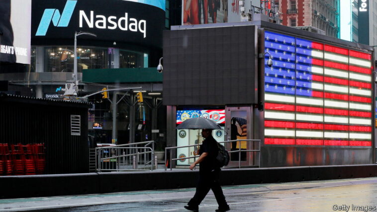 NEW YORK, NEW YORK - OCTOBER 4: A man crosses the street near Nasdaq Headquarters at Times Square on October 4, 2022 in New York City. Nasdaq led Wall Street higher as easing U.S. Treasury yields boosted megacap growth and technology stocks. (Photo by Leonardo Munoz VIEWpress/Getty Images)