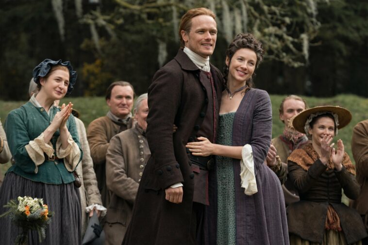 OUTLANDER, from left: Caitlin O'Ryan, Sam Heughan, Caitriona Balfe, The Fiery Cross, (Season 5, Episode 501, aired Feb. 16, 2020). photo: Aimee Spinks / Starz / Courtesy Everett Collection