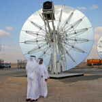 Men stand in front of solar panels at the Mohammed bin Rashid Al Maktoum Solar Park in Dubai, November 28, 2015. REUTERS/Stringer - GF20000077834