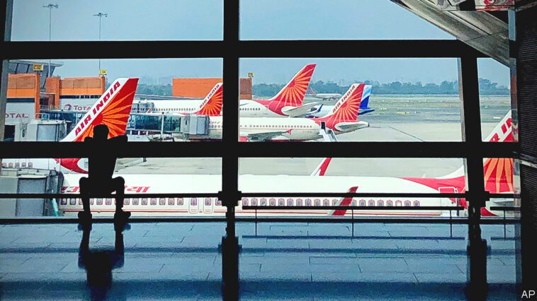 FILE- Air India planes are parked at Indira Gandhi International Airport in New Delhi, India on Aug. 30, 2021. Indian police have arrested an unruly airline passenger following a complaint by a woman aboard an Air India flight from New York that he urinated on her in business class. (AP Photo/Manish Swarup, File)