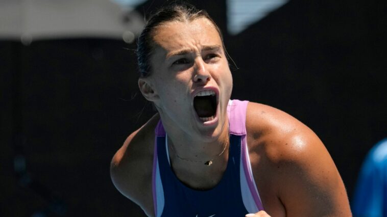 Aryna Sabalenka of Belarus celebrates after defeating Belinda Bencic of Switzerland in their fourth round match at the Australian Open tennis championship in Melbourne, Australia, Monday, Jan. 23, 2023. (AP Photo/Aaron Favila)