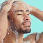 Man washing his hair in the shower