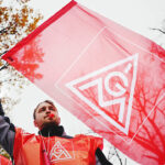 Mandatory Credit: Photo by CLEMENS BILAN/EPA-EFE/Shutterstock (13627429d)A participant waves a flag of German metalworkers' union IG Metall during a warning strike of the Mercedes-Benz plant employees in Berlin, Germany, 17 November 2022. German metalworkers' union IG Metall demands a payment rise of eight percent.Warning strike of German trade union IG Metall in Berlin, Germany - 17 Nov 2022