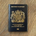 New British passport. Flat lay of post-Brexit blue black UK passport cover.