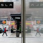 NEW YORK, NEW YORK - JANUARY 03: A man walks near Tesla showroom on January 03, 2023 in New York City. Tesla Inc. shares started 2023 by plunging more than 13% as they fell to $106.50 a share . (Photo by Leonardo Munoz/VIEWpress)