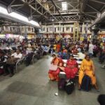 Passengers wait at Howrah railway station after several trains were cancelled due to Bharat Bandh, called to protest against Centre