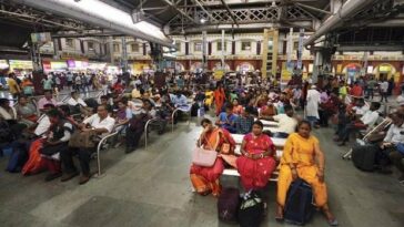 Passengers wait at Howrah railway station after several trains were cancelled due to Bharat Bandh, called to protest against Centre