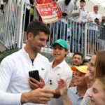 Tennis - Adelaide International - Memorial Drive Tennis Club, Adelaide, Australia - January 3, 2023 Serbia's Novak Djokovic with fans after winning his first round match against France's Constant Lestienne