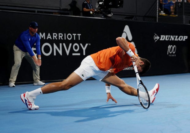 Tennis - Adelaide International - Memorial Drive Tennis Club, Adelaide, Australia - January 7, 2023 Serbia's Novak Djokovic reacts after sustaining an injury during his semi final match against Russia's Daniil Medvedev