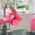 Person cleaning the kitchen sink