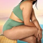 A plus-sized woman on a colourful background