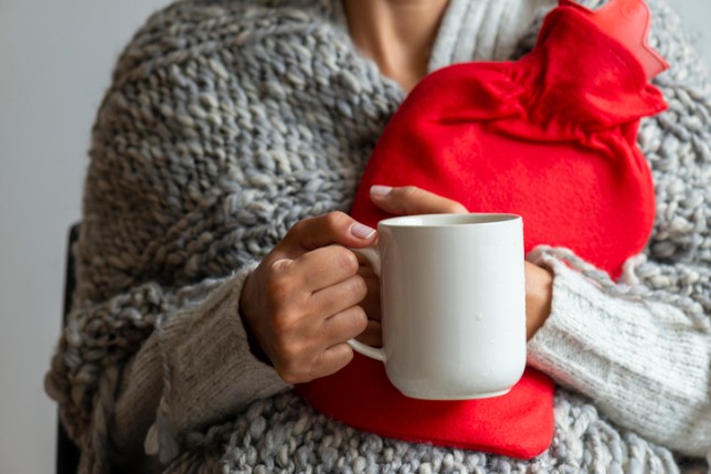 woman holding hot water bottle