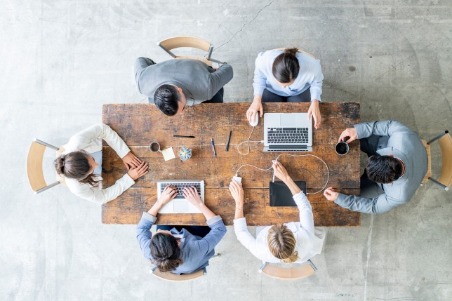 A group of people working on a desk