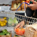 shopping basket with groceries in supermarket