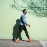 man walking on pavement