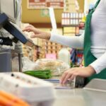 Cashier ringing up groceries