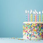 Birthday cake decorated with colorful sprinkles and ten candles