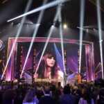 LOS ANGELES, CALIFORNIA - MARCH 27: (FOR EDITORIAL USE ONLY) (L-R) Taylor Swift accepts the Song of the Year award for