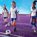 schoolgirls playing football