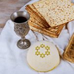 High Angle View Of Matzo With Wine And Haggadah on table