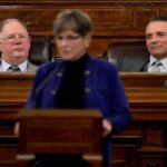 Daniel Hawkins (l.) passed the bill, overriding a veto by Gov. Laura Kelly (center)