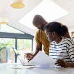 Couple paying bills online at home