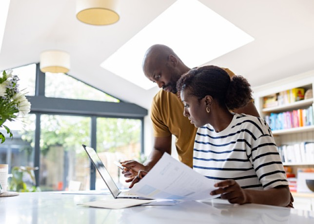 Couple paying bills online at home