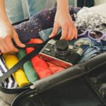 Packing a suitcase with clothes