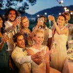 Wedding guests toasting with champagne during wedding reception in garden