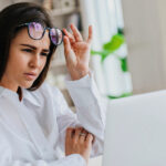 businesswoman at desk reading on a computer