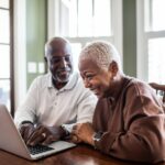 A senior couple looking at a laptop