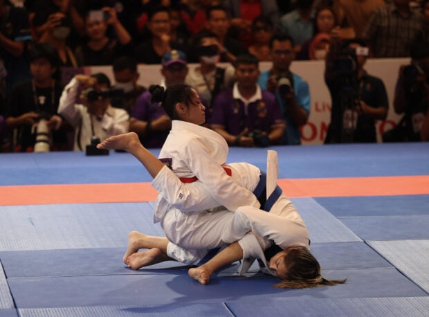 Kaila Napolis of the Philippines locks up Cambodia’s Jessa Khan.