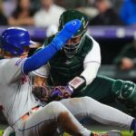 May 27, 2023; Denver, Colorado, USA; Colorado Rockies catcher Elias Diaz (35) tags out New York Mets third baseman Brett Baty (22) in the sixth inning at Coors Field.